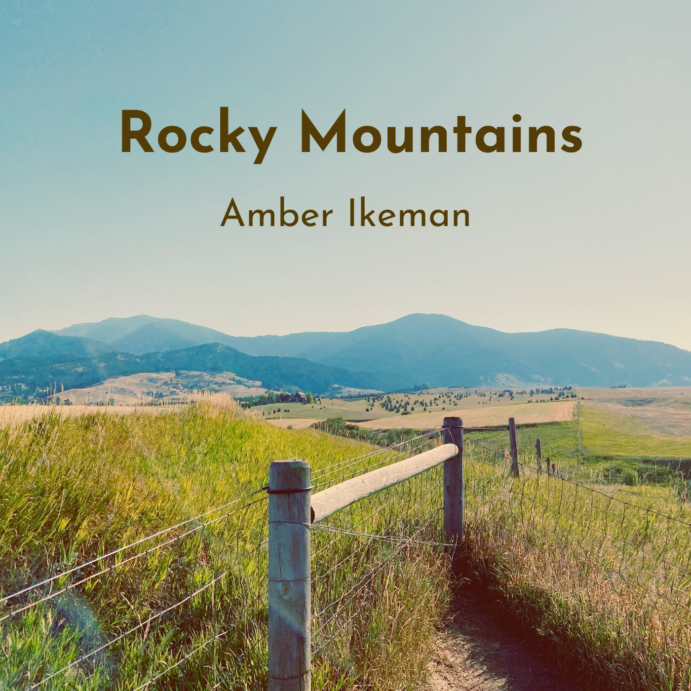 Album cover: an open field with blue, curving mountains in the distance